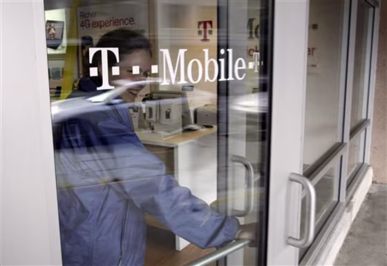 A customer walks out of a T-Mobile store in Palo Alto, Calif., Friday, Feb. 25, 2011. Subscribers on contract-based cell phone plans hung up on T-Mobile USA in record numbers in the fourth quarter, as it continues to lose the battle against larger carriers.